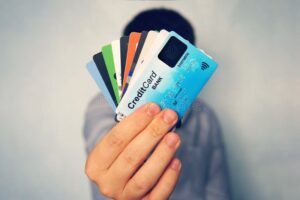 Qué son las tarjetas que absorben deudas de otros bancos y cómo funcionan 45 manos intercambiando tarjetas de credito coloridas