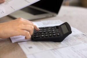 persona revisando finanzas con calculadora y dinero